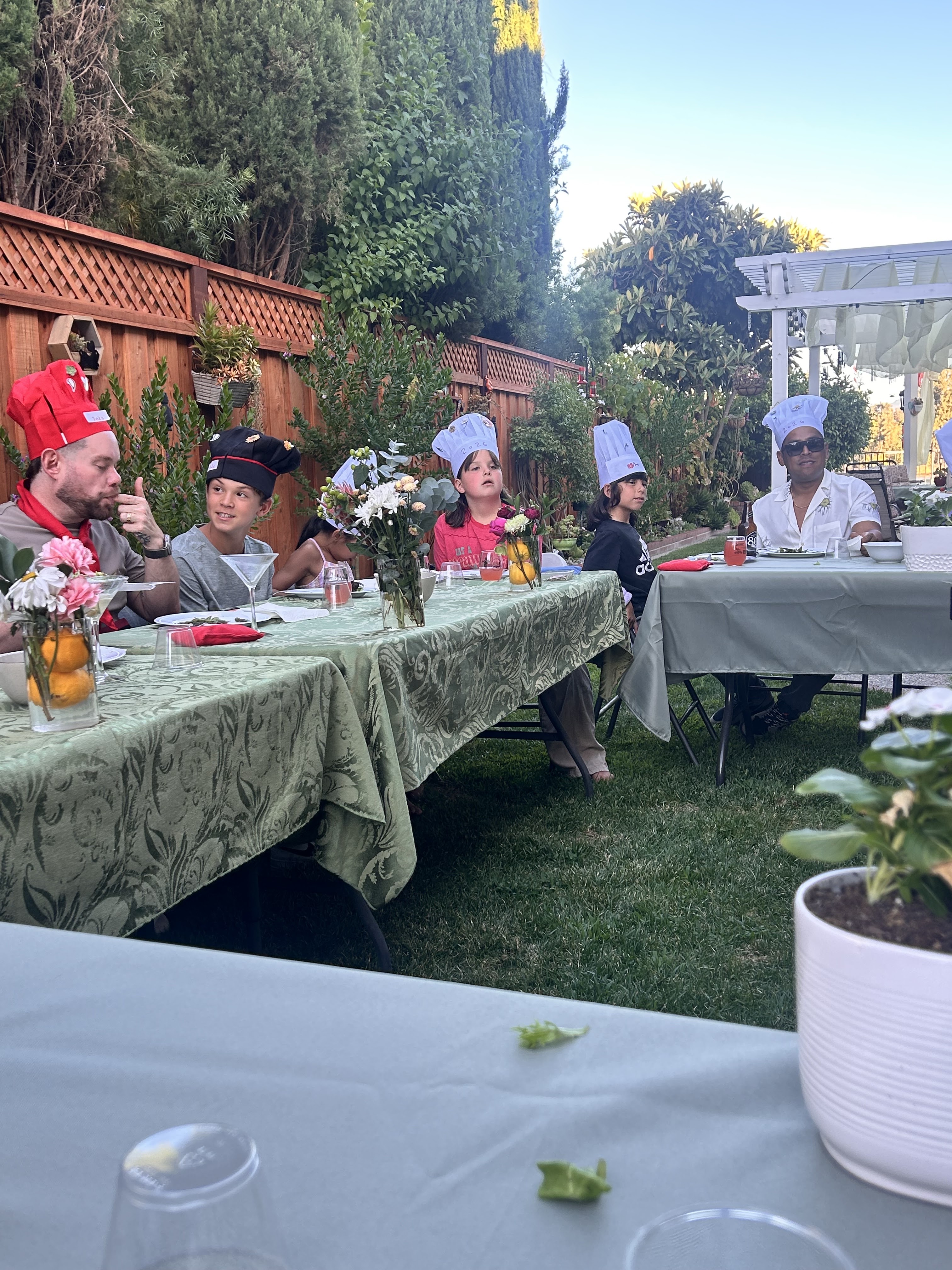 Family wearing chef hats with the hibachi chef in El Dorado Hills, CA