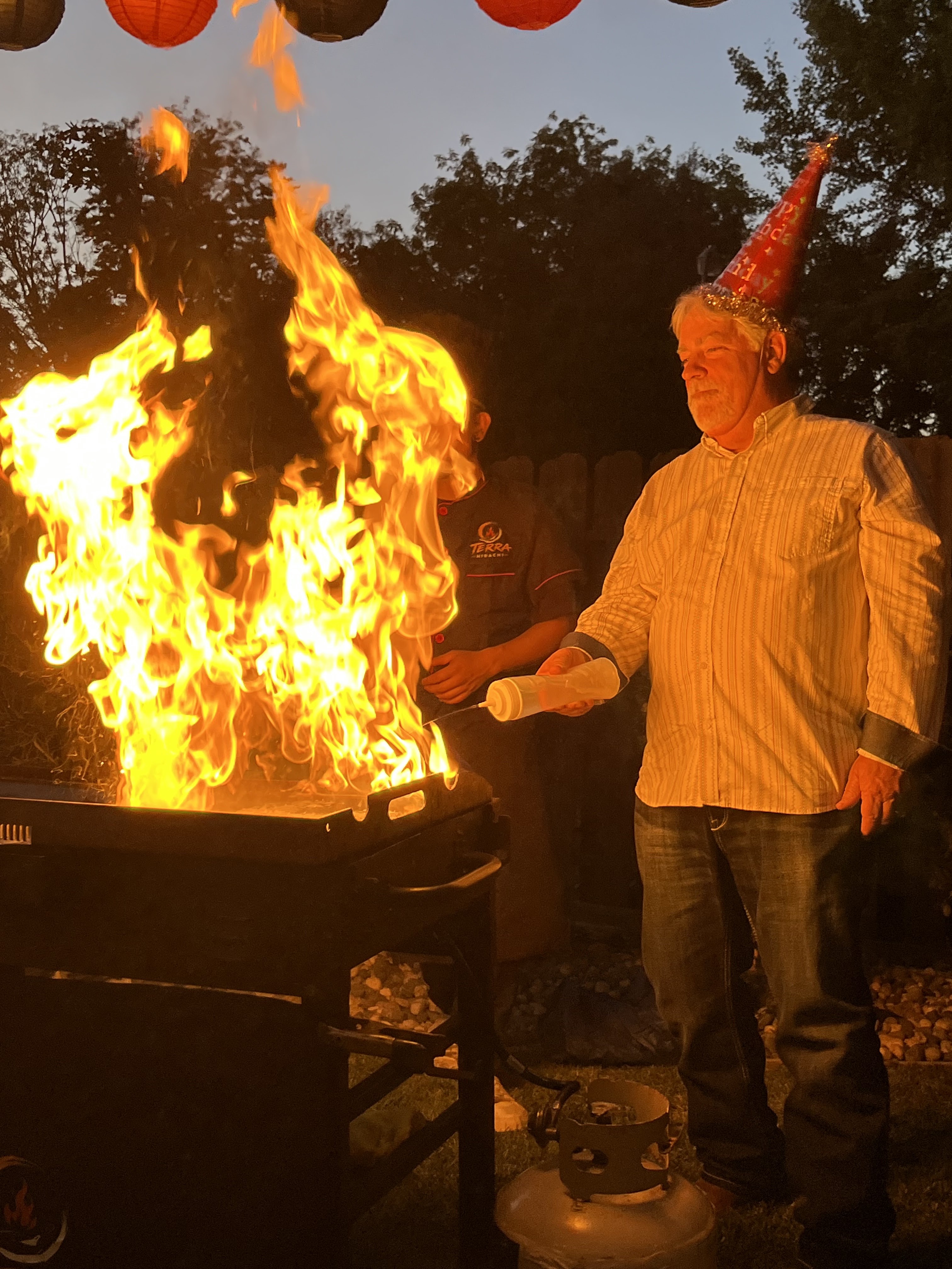 Live hibachi grill flames at a backyard party in El Dorado Hills, CA